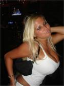 94070_Blonde_woman_in_white_clubwear_top_shows_off_her_large_boobs.